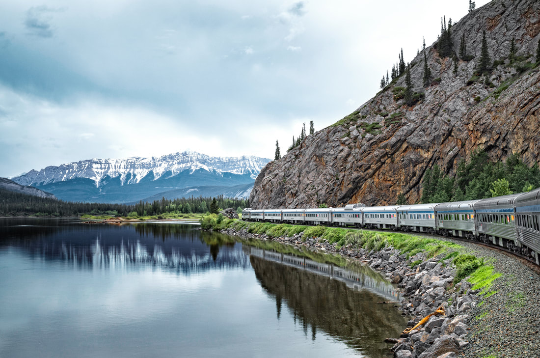 long train by jasper rocky mountains and lake